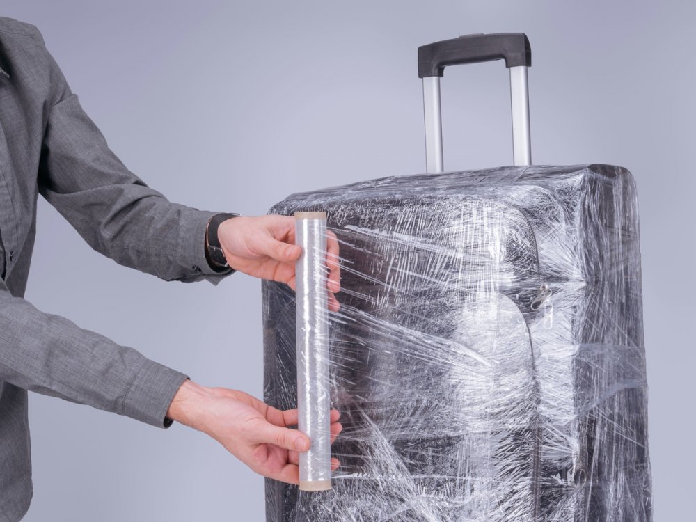 man-wraps-suitcase.jpg